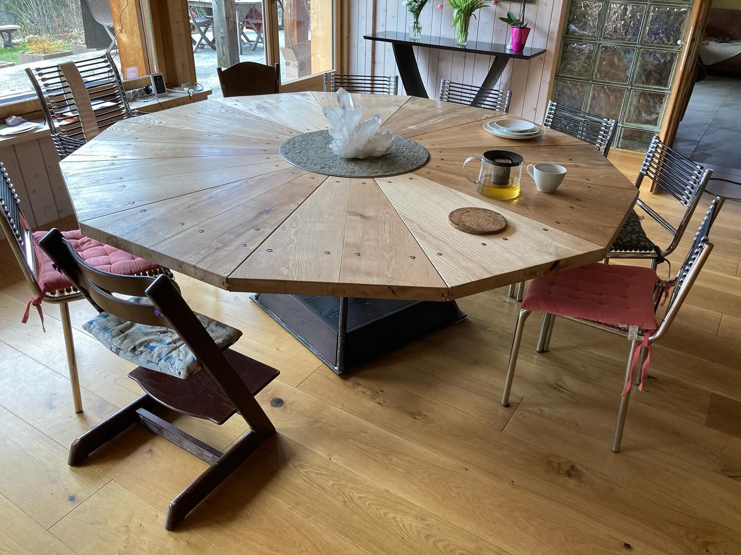 Wooden 10-sided table with a crystal embedded in the  middle.