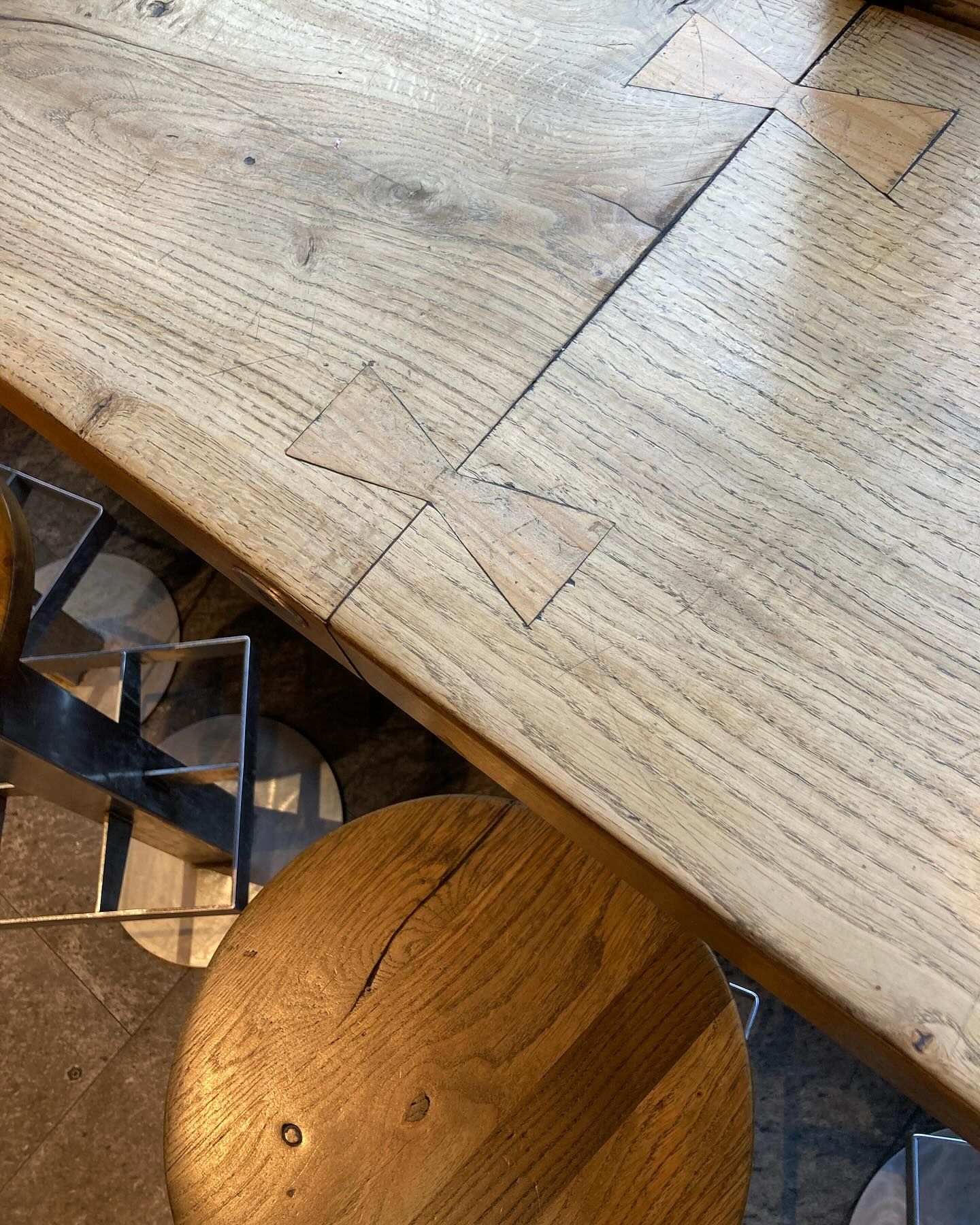 Top view of part of table where two pieces of wood are kept together with a butterfly joint.