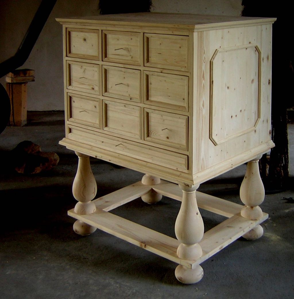 Drawers raised on four legs. There are nine drawers in a 3 by 3 pattern.